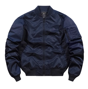 Detailed view of dark blue MA-1 flight jacket with nylon texture and utility arm pocket
