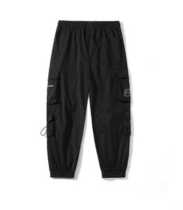Detail of black cargo pants featuring multi-pockets with a letter B print on the pocket flap