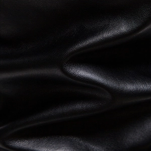 Close-up macro detail showing high-quality black faux leather texture with fine grain finish