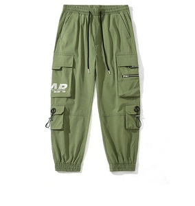 Detail of olive green cargo joggers with multiple pockets and tactical ring zippers