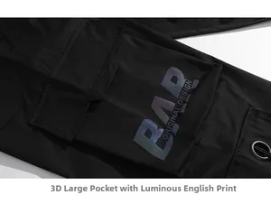 Detail of cargo pants showing side pocket with reflective BAR ORIGINAL DESIGN print
