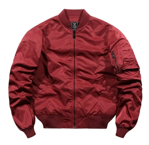 Detail of burgundy MA-1 flight jacket showing utility sleeve pocket and ribbed collar