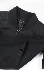 Detail of ribbed collar and snap-flap pocket on a black MA1 bomber jacket for men