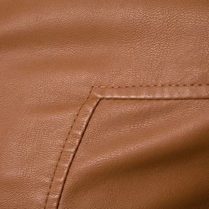 Close-up of brown PU leather jacket with premium lychee grain texture and neat double stitching