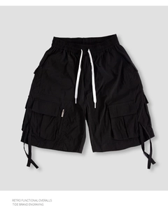 Detail of black tactical cargo shorts with adjustable drawstring waist and functional pockets
