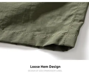 Detailed macro view of the army green cargo shorts featuring durable double-stitched hem finish