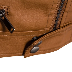 Detailed close-up of brown PU leather jacket with lychee texture and metallic hardware