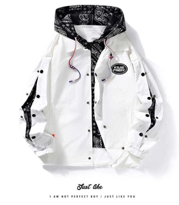 Detail of white hooded jacket showing paisley lining and adjustable button sleeves