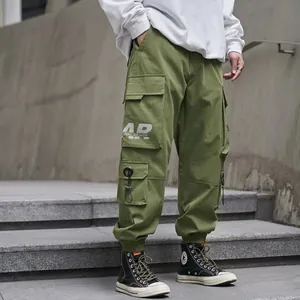 Olive green men's cargo pants with multi-pockets and drawstring cuffs in urban streetwear style
