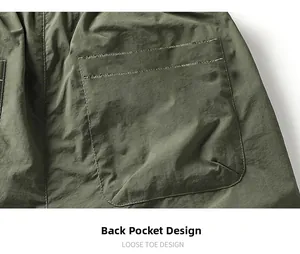 Detail of army green cargo shorts showing reinforced back pocket stitching and fabric texture