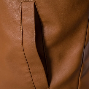 Close-up of caramel brown PU leather jacket featuring lychee texture and fine stitching