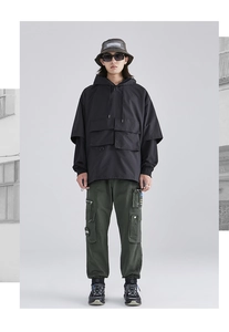 Close-up detail of urban techwear cargo pants with multiple functional side pockets