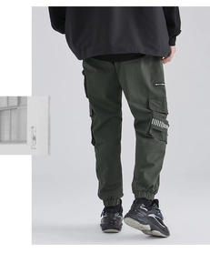 Rear view of dark green techwear cargo pants with side pockets and letter print