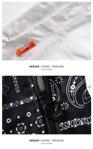 Detailed view of the paisley print fabric and orange woven label on the baseball jacket