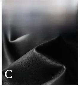 Close-up detail of premium black PU leather texture with fine grain and matte finish