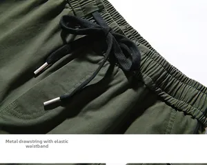 Detail of army green cargo pants featuring an elastic waistband and black drawstrings