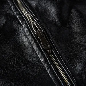 Close-up of black leather jacket texture with high-quality silver metal zipper detail