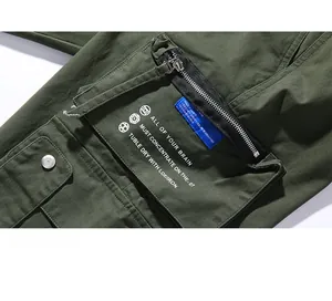 Detail of military green cargo pants featuring 3D zipper pocket and street style prints