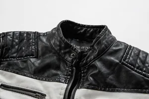 Détail de la veste en cuir avec col montant, boutons-pression et poches zippées
