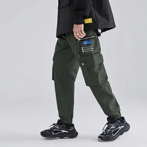 Men's dark green cargo pants featuring techwear multi-pockets and functional aesthetic