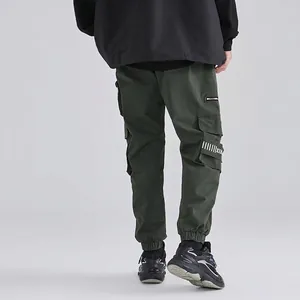 Men's dark green military cargo joggers with large side pockets and elastic cuffs