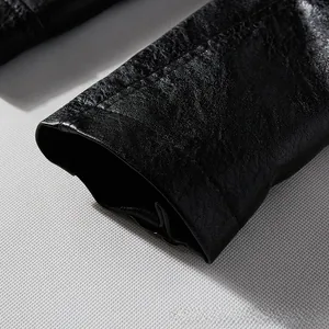 Detailed close-up of high-quality synthetic leather texture and sleeve stitching on black jacket
