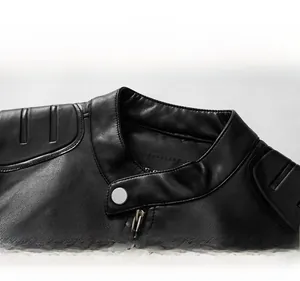 Detail of black faux leather jacket featuring a stand collar with snap button and zipper