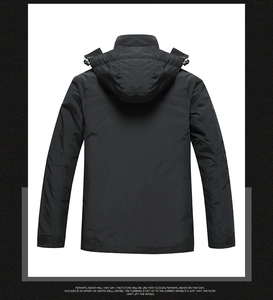 Rear view of black waterproof outdoor jacket with adjustable hood and velcro cuffs