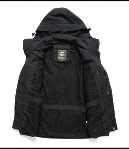 Detail showing breathable mesh lining and interior pocket of a black outdoor jacket