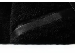 Detailed macro view of black faux shearling lining and premium leather jacket texture
