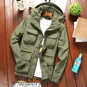 Close-up of military green outdoor jacket featuring large pockets and classic embroidery
