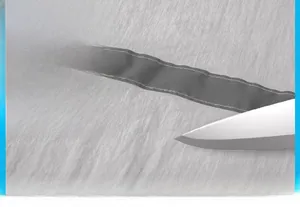 Detail showing high-density ripstop grey fabric being tested for scratch resistance