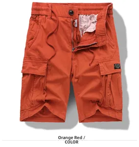 Detail of men's orange cargo shorts with elastic drawstring waist and large flap pockets
