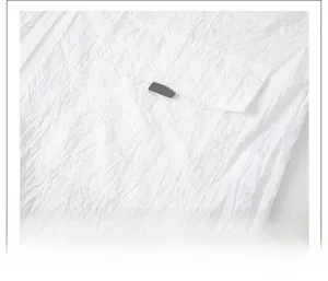 Detail of lightweight breathable fabric and large patch pocket on white sun protection jacket