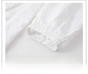 Detail of elastic cuff on ultra-thin white sun protection jacket with pleated texture
