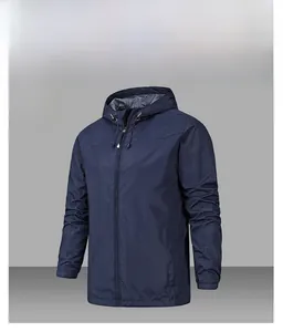 Detail of waterproof denim blue outdoor jacket with adjustable hood and elastic cuffs