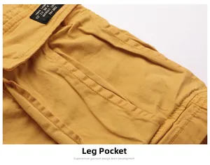 Detailed macro view of ginger yellow cargo shorts featuring flap pocket and woven label