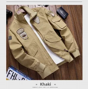 Detail of khaki military bomber jacket with vintage patches and elastic ribbed cuffs