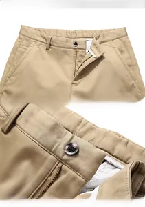 Detail of khaki casual pants featuring waist structure, resin button and metal zipper fly