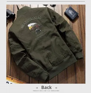 Detail of army green bomber jacket back featuring eagle embroidery and tactical branding