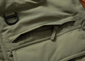 Olive green lightweight outdoor jacket with zip pocket and metal D-ring attachment