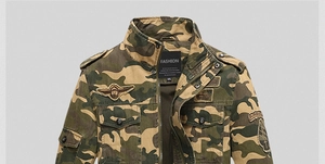 Detailed view of camouflage military jacket with embroidered Airborne patches and stand collar
