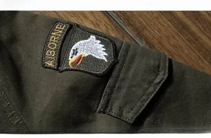 Close-up of airborne eagle embroidery on military green outdoor jacket shoulder