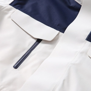 Close-up of functional outdoor jacket showing waterproof zipper pocket and fabric texture
