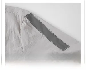Detail view of smooth shoulder seams and grey contrast trim on lightweight sun protection jacket