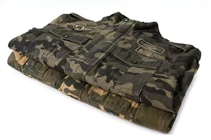 Detail of camouflage jacket showing embroidered badges and metal buttons on twill fabric