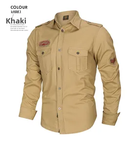 Close-up of military style khaki shirt with dual chest pockets and red embroidered badges