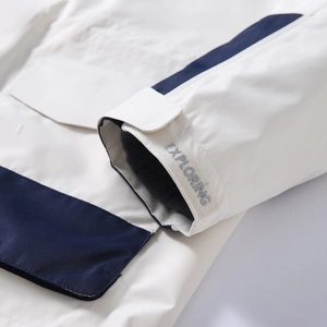 Macro detail of the adjustable velcro cuff with Exploring text on an outdoor jacket