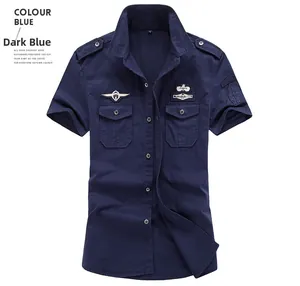 Detail of dark blue military short sleeve shirt with badges, epaulettes and chest pockets