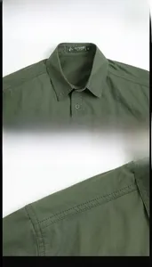 Detailed close-up of army green tactical shirt featuring reinforced collar and shoulder seams